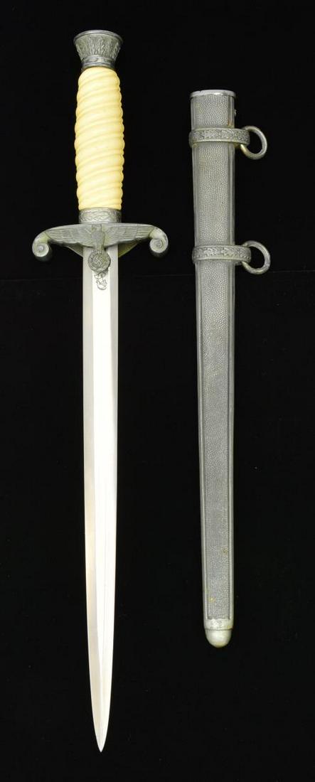 REPRO. WKC GERMAN ARMY DAGGER.: Overall length: 15.5". Blade length: 10.25". Marked "WKC / SOLINGEN". Vanilla colored grip w/ wood liner. Plated mounts. CONDITION: very good overall appearance. Mounts show tarnish & areas of polishi