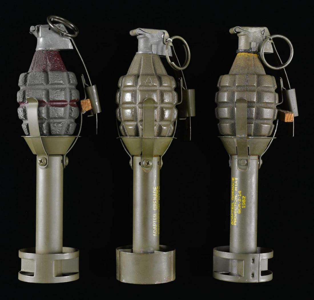 3 KOREAN & VIETNAM WAR M1A2 GRENADE LAUNCHER: ADAPTERS WITH 3 INERT MK II GRENADES. OD green painted adapters. One dated 1952 w/ 3 prongs. 2 Have WWII dates w/ 1969 modification from 4 prongs to 3 prongs w/ new drilled locations. Accompanied by 3