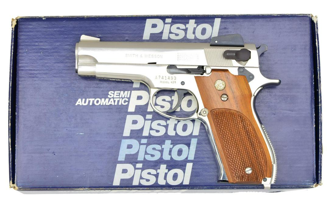 NICKEL PLATED LIGHTWEIGHT SMITH & WESSON MODEL 439: PISTOL. Cal. 9mm. S# A741493. Bbl. 4". Alloy frame lightweight nickel plated traditional dbl. action pistol. Fixed blade front sight w/ adj. rear. Left side controls. Two piece checkered grips w/ gold