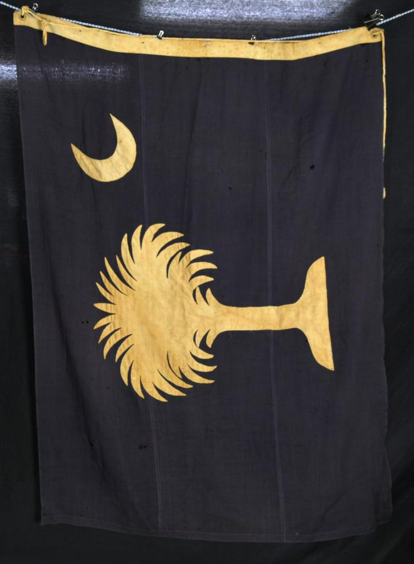 SOUTH CAROLINA REUNION ERA STATE SEAL FLAG FROM: CHARLESTON CONFEDERATE MUSEUM. 53X71". Wool bunting, double applique cotton crescent & palmetto tree. 2" Linen hoist w/ 2 brass grommets, has been modified w/ 6 sewn small brass rings & rope attachmen