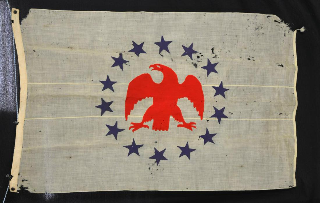 19TH CENTURY EAGLE & STARS MARITIME FLAG.: 46" x 70". 14 Hand sewn dbl. applique 4.5" blue twill stars in circle surrounding 18" sewn through red tightly woven single ply wool eagle. About 2", 2 ply heavy cotton sleeve on leading edge has appa