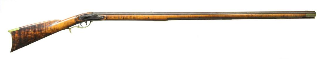 EARLY SNYDER COUNTY MULE EAR RIFLE BY SAMUEL BAUM.: Cal. 38. NSN. 39 1/4" full oct. rifled bbl. signed â€œSB”. This curly maple stocked rifle has no patchbox & is decorated w/ only a brass inlay on face of cheekpiece. Has 4" iron sideplate & 