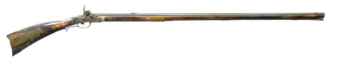 PERCUSSION KENTUCKY RIFLE ATTRIBUTED TO GEORGE: SMITH BY OWNER. Cal. 50 smooth bore. NSN. Bbl. 40" oct. to rnd. is unmarked. Percussion lock is unmarked. Sideplate is heavy beveled brass. Stock is incise carved behind cheekpiece. The gun has 14 sil