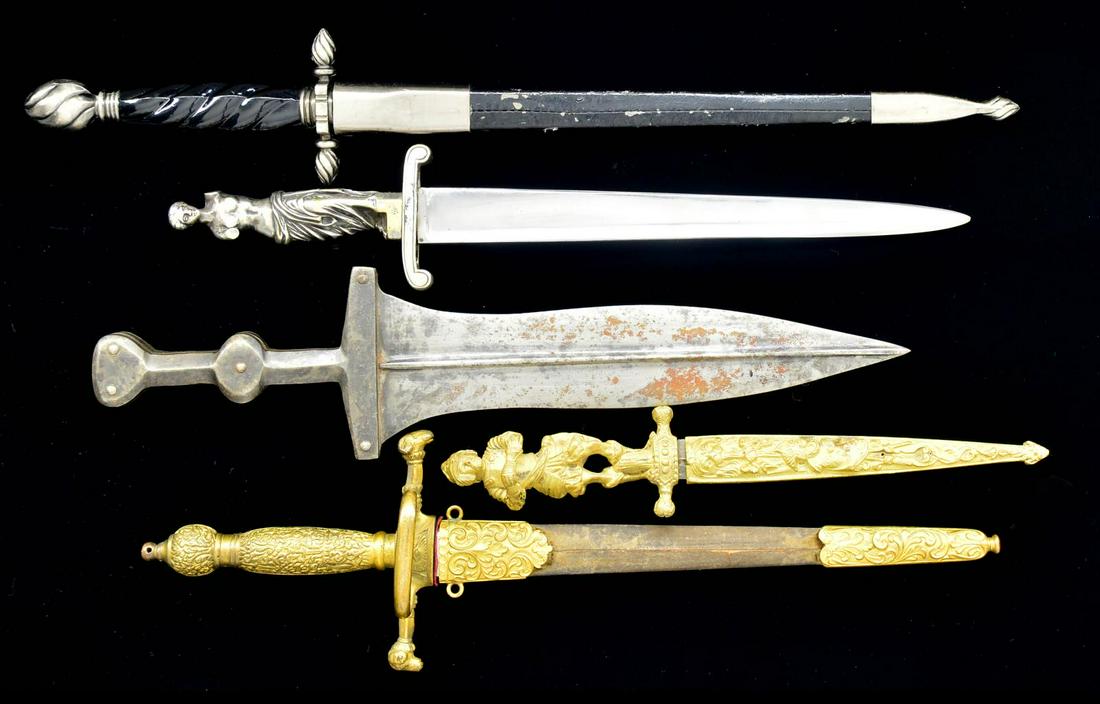 5 DAGGERS & KNIVES.: 1) MASONIC DAGGER. Overall length: 14 1/4". A good example of a 19th or early 20th century dagger w/ Masonic motifs. Plain blade w/ raised medial ridge. Gilded brass hilt w/ramâ€™s head terminals