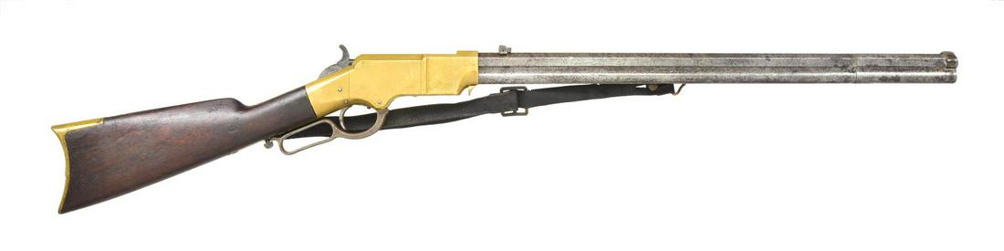 HENRY LATE MODEL BRASS FRAME RIFLE.: Cal. 44 HRF. S# 6724. The 24" octagonal barrel with integral magazine tube has 5" pivoting muzzle section for loading. Barrel is fitted with bottom portion of original sight, long range staff broken o