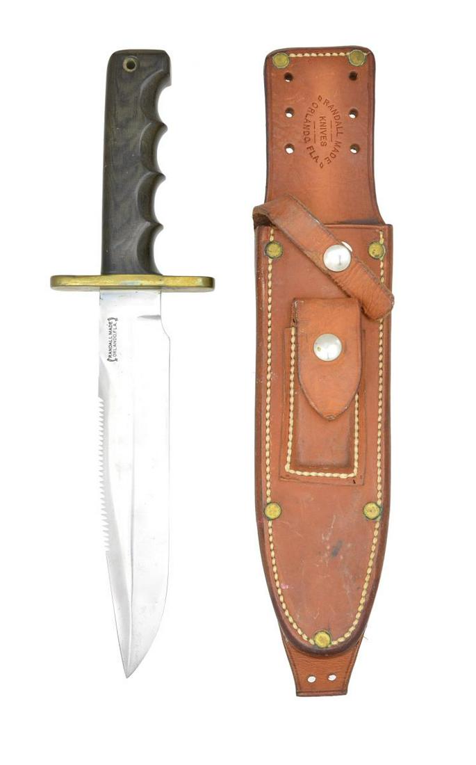 RANDALL SAWBACK SURVIVAL KNIFE.: Overall length: 12 1/4". Blade length: 7 1/2". Sawback dual edged blade. Blade is stamped â€œ(sword) RANDALL MADE / ORLANDO, FLA. (sword)”. Brass crossguard. Gray/brown micarta 4 finger form