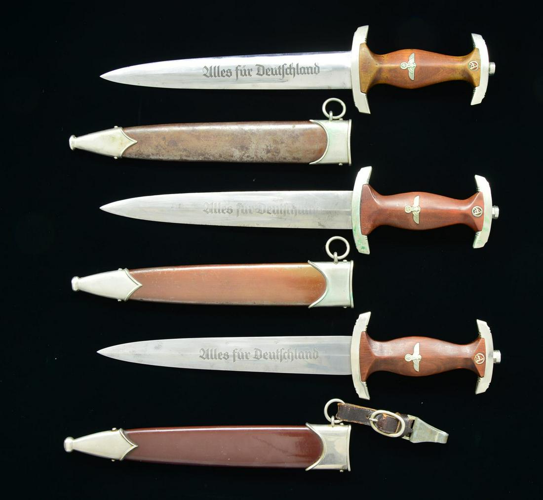 3 WWII GERMAN SA DAGGERS.: 1) GROUND ROHM SA. Overall length: 14 9/16". Blade is etched, "Alles fur Deutschland" on the front and is marked, "E.P. & S. (logo) SOLINGEN." on the reverse. The reverse shows the unmistakable signs