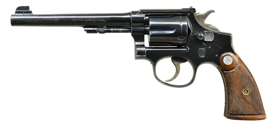 SMITH & WESSON MODEL K-22 OUTDOORSMAN REVOLVER.: Cal. 22 LR. S# 655425. Bbl. 6" pinned w/ Call silver bead pinned factory blade; opposing screw adj. rear sight contoured to top strap. Blued 1st model mfg. 1931-1940 w/in M&P 1905 4th change series (S