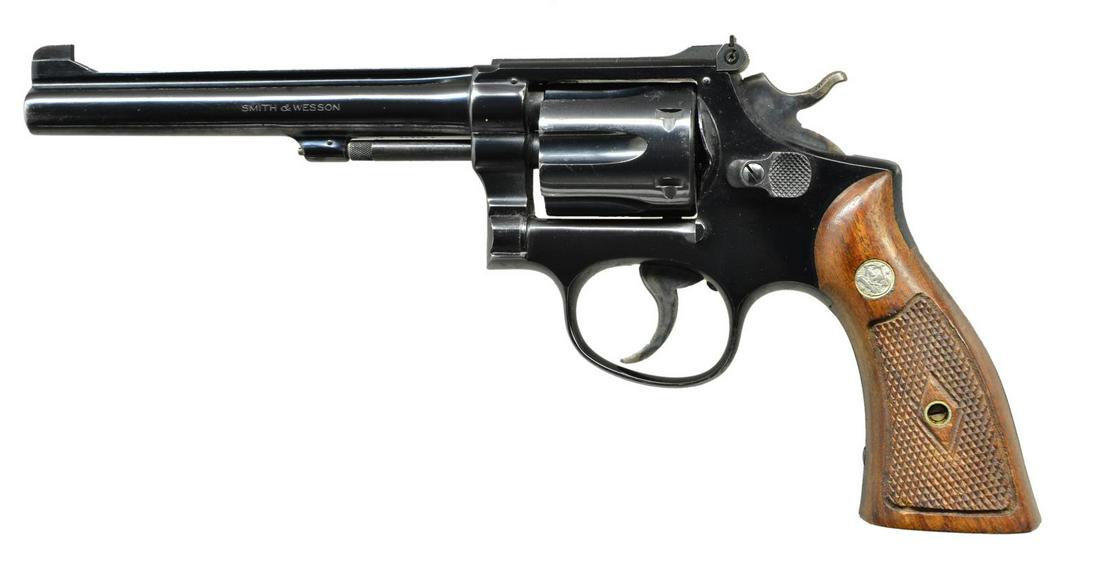 SMITH & WESSON K22 DA REVOLVER.: Cal. 22 LR. S# K242026. Bbl. 6" with rib. Serrated ramp patridge front sight with square notch adjustable rear sight. 6 Shot fluted cyl. K frame pinned and recessed 5 screw action. Blue finish with ca