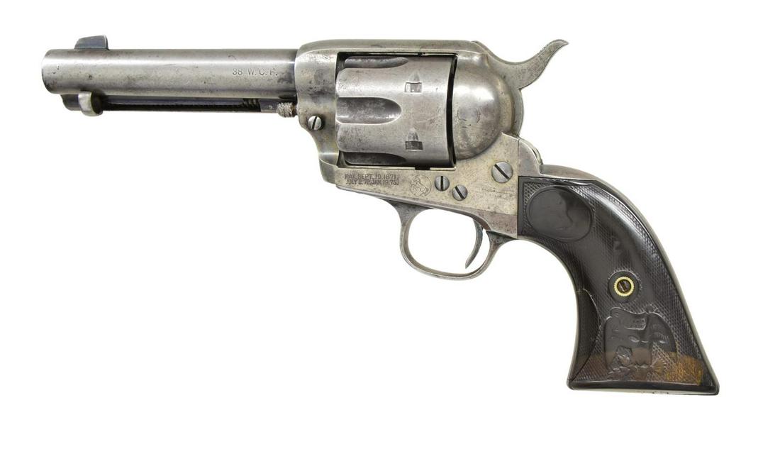 COLT FIRST GEN SAA REVOLVER.: Cal. 38 WCF (38-40). S# 172407. Bbl. 4 3/4". 6 Shot fluted cylinder. Blue and case colored finish. 2 Piece checkered hard rubber eagle grips. Butt of right panel has hand carved initials "L.C.L." Butt
