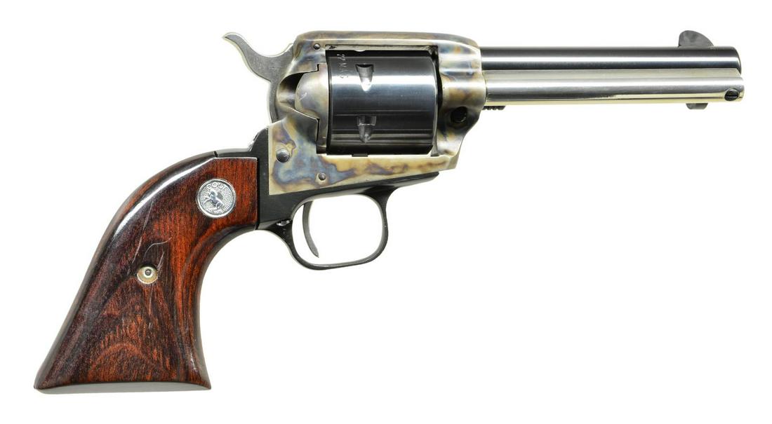 COLT PEACEMAKER 22 SCOUT SA REVOLVER.: Cal. 22 Mag. S# G178411 (1976). Case colored frame, blued 4.4" bbl., fixed sights, 6 shot rnd. cyl., black anodized grip frame, bright ejector housing & replacement 2 piece wood grips w/ Colt medallio