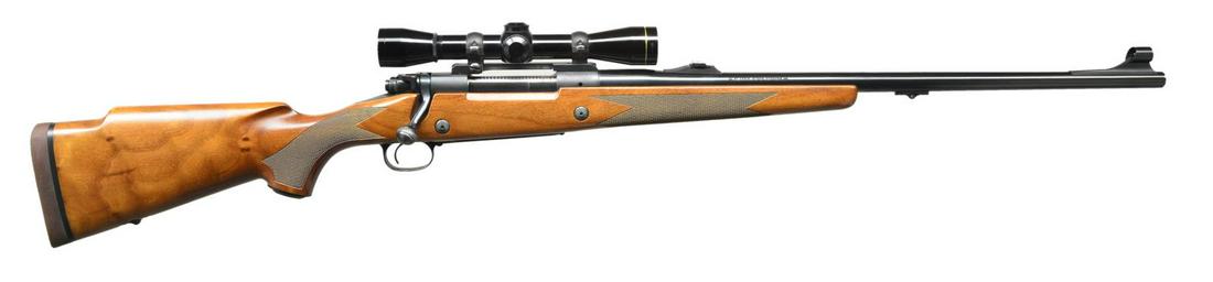 WINCHESTER MODEL 70 CLASSIC SUPER EXPRESS BOLT: ACTION RIFLE. Cal. 375 H&H Mag. S# G61426. Bbl. 24" heavy weight with ramp mounted hooded bead front sight and island mounted folding leaf Express rear sight. Leupold M8-4X32 gloss finished scope with