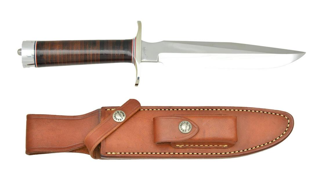 RANDALL MADE MODEL 1 ALL PURPOSE FIGHTING KNIFE.: Overall: 12 1/4". Blade: 7". Nickel silver dbl. hilt. Leather washer handle. Duralumin buttcap. UNATTACHED ACCESSORIES: "7" marked Randall Made brown leather sheath w/ sharpening stone & instructions.