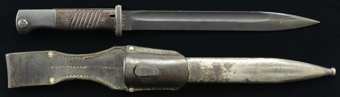 WWII GERMAN KREIGSMARINE MODEL 1884/98 III BAYONET: BY MUNDLOS IN 1939. Overall: 15 1/4". Fullered 10" blade. 2 Piece plastic grips w/ grooves & screws. Eagle 243 proofs on pommel & button. Crossguard is marked "0.6997P". Matching numbered steel scabba