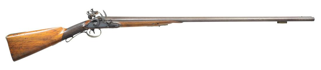 UNMARKED EUROPEAN STYLE FLINTLOCK SXS SHOTGUN.: Cal. 20 Bore. NSN. Twist pattern 33" bbls. w/ swamped rib, front stud & brass pipe. Unmarked locks w/ light scroll ornamentation on hammers. Wedge fastened walnut stock w/ skip line checkering. Ornate