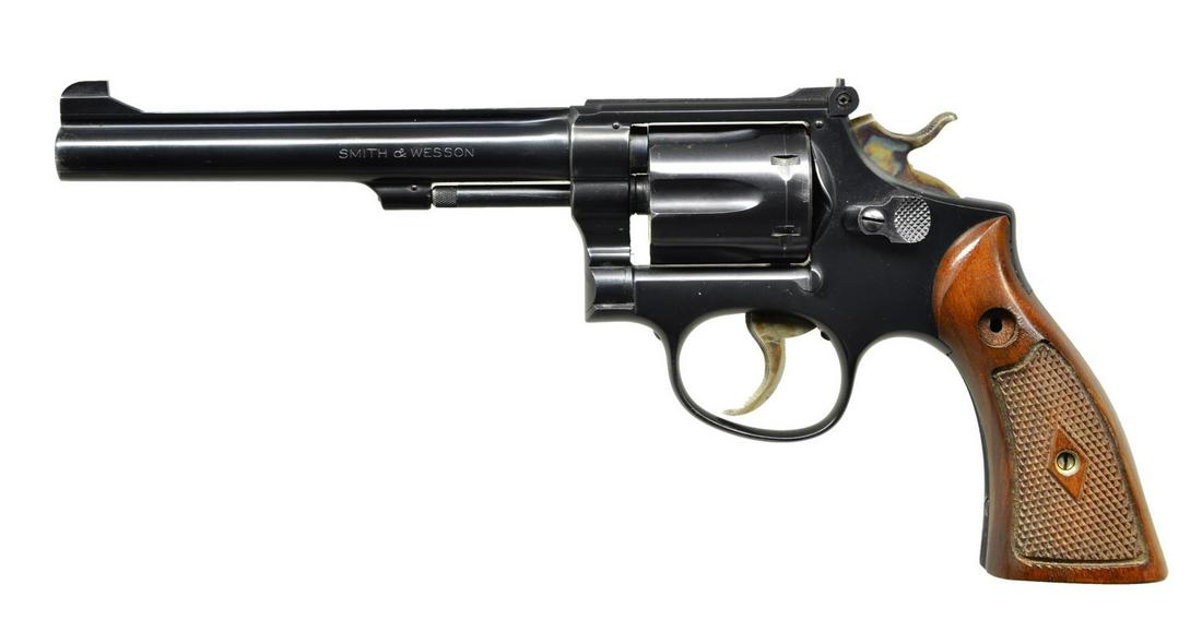 SMITH & WESSON K22 DA REVOLVER.: Cal. 22 LR. S# K135641. Bbl. 6". Micrometer rear sight & Patridge front sight. Blued finish w/ case colored hammer & trigger. Checkered Magna walnut grips. Right grip panel numbered matching to frame.