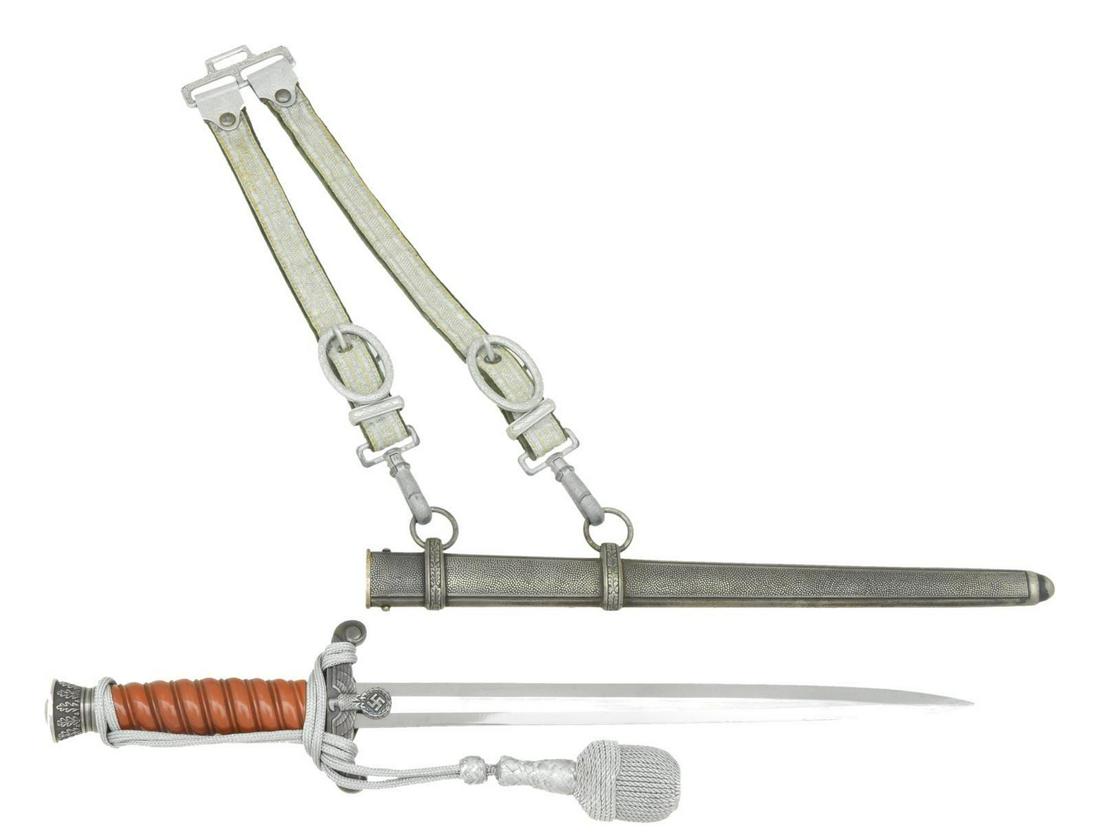 WWII GERMAN PRESENTATION ARMY MAJOR'S DAGGER.: Overall length 15 3/4”. Plain blade marked near the hilt “A. W. JR (logo) SOLINGEN”. Plated eagle decorated cross guard with the following inscription on the reverse “Unserem h