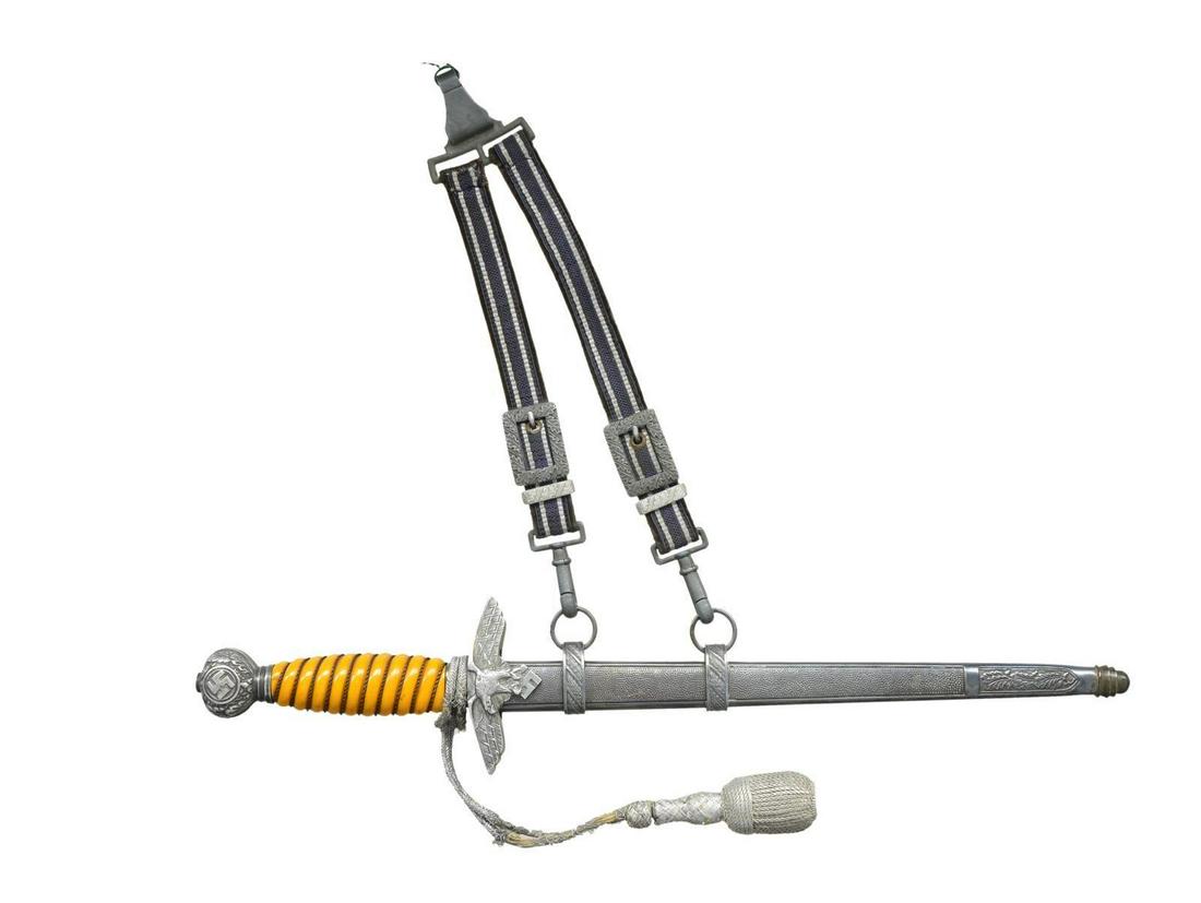 WWII GERMAN 2ND MODEL LUFTWAFFE DAGGER.: Overall length 17”. Plain blade marked on the reverse “H.KOLPING SOLINGEN (logo).” Aluminum eagle cross guard & pommel. Wire wrapped orange composite grip with knot attached. Plated