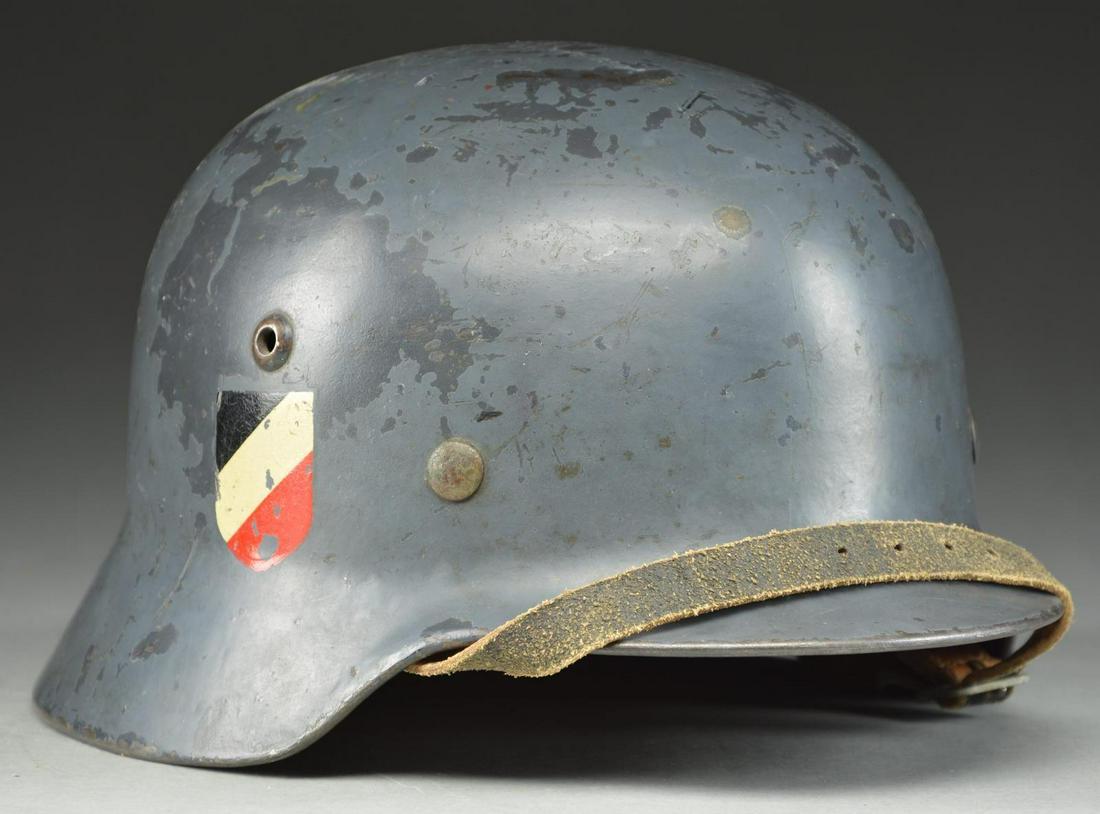WWII GERMAN M1935 LUFTWAFFE DOUBLE DECAL HELMET.: This helmet has a deep steel blue repainted finish likely done at the factory. The left side shows an early “snake leg” Luftwaffe decal and the right side shows the National Color decal. T