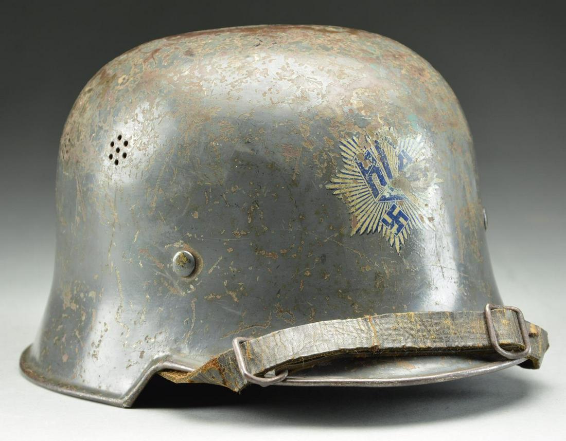 WWII GERMAN EARLY MODEL LUFTSCHUTZ HELMET.: A seldom seen example of a civic square-dip helmet style utilized by the RLB. This early example has a light blue-gray painted finish with a white & blue RLB multi-rayed 8-pointed star decal on the fr
