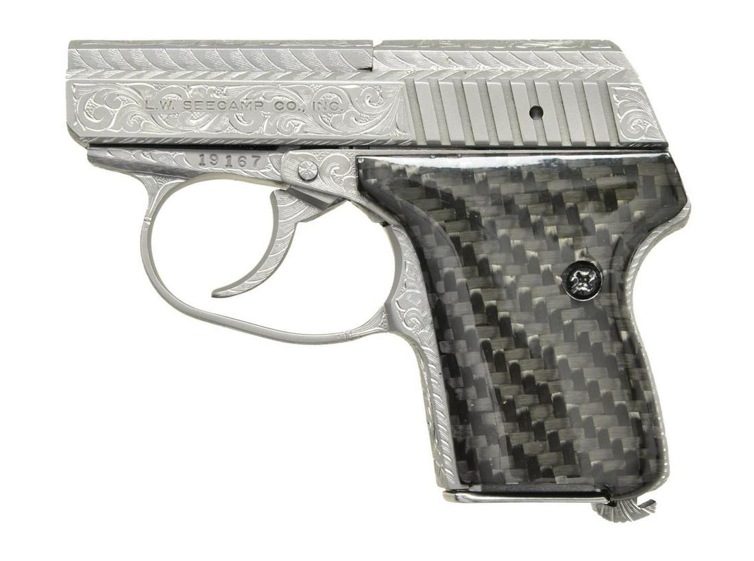 VALADE FULLY ENGRAVED SEECAMP 32 PISTOL.: Cal. 32 ACP. S# 19167. Bbl. 2". As if the Seecamp pistols aren't desirable enough, this one has been completely engraved by Master Engraver Robert Valade in a scroll type vine pattern. From the top of