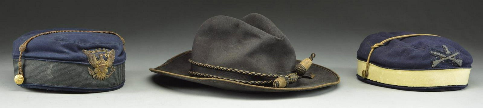 GROUP OF THREE SCARCE AMERICAN VINTAGE MILITARY: HATS. 1. Slouch hat, black felt, sewn silk edging, 1.75” patent leather sweatband, size 7 label. Tied black ribbon with flat bow and Civil War/ Indian War era officer’s hat cord with acorn
