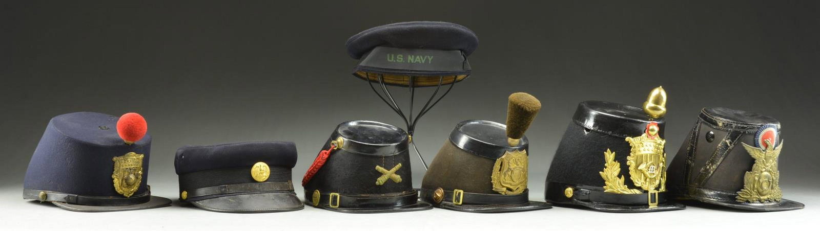 US MILITARY HATS, HELMETS & PARTS.: 1) NAVY. WWII era US Navy “Donald Duck” style hat. Cap tally reads “U.S. NAVY”. Interior sweat shield. CONDITION: hat shows notable mothing. 2) NAVY. A late 19th century US Nav