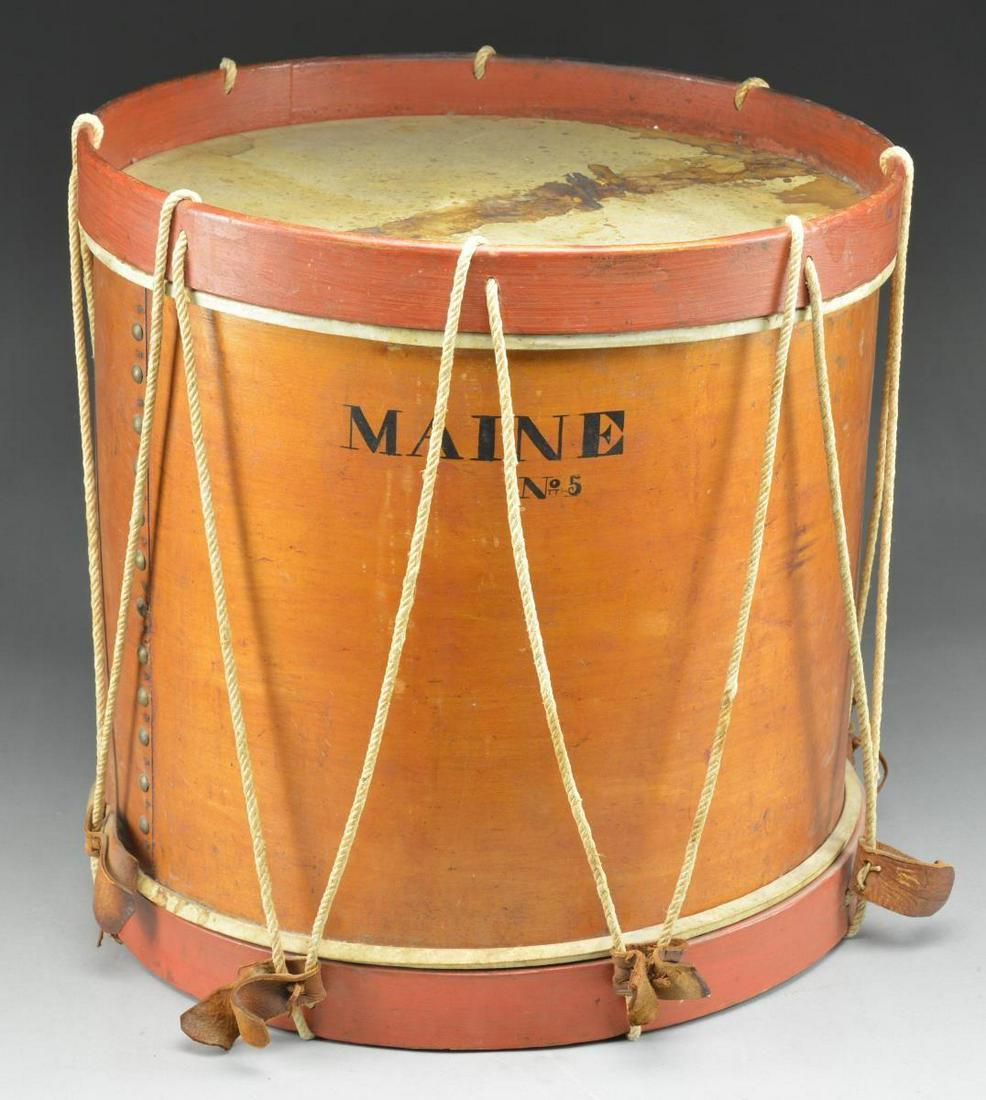 A WONDERFUL EARLY MAINE MILITIA DRUM FROM THE: AROOSTOOK COUNTY WAR PERIOD. This drum measures 18 1/2" in height with a diameter of 16 3/4". It has dull red painted rims as often seen on early Maine drums. The body of the drum has brass domed tack
