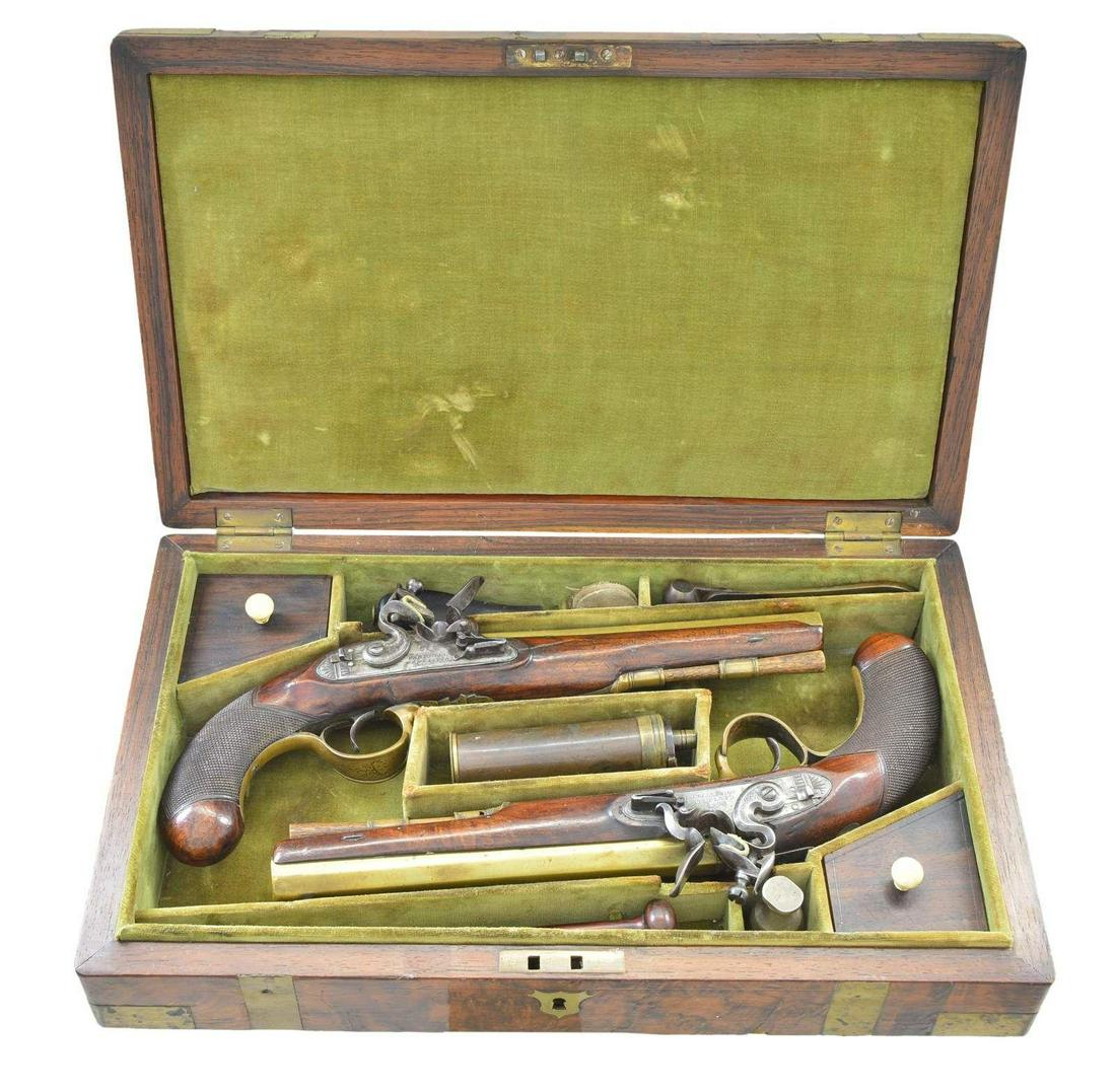 PAIR OF BRASS BARREL FLINTLOCK HOLSTER PISTOLS BY: CARTMELL OF DONCASTER, YORK. Cal. 52. NSN. The 7 5/8" swamped octagon brass barrels without patent breeches are engraved "BRISTOL" on tops. Barrels are unproofed. Feather engraved breech irons have "V