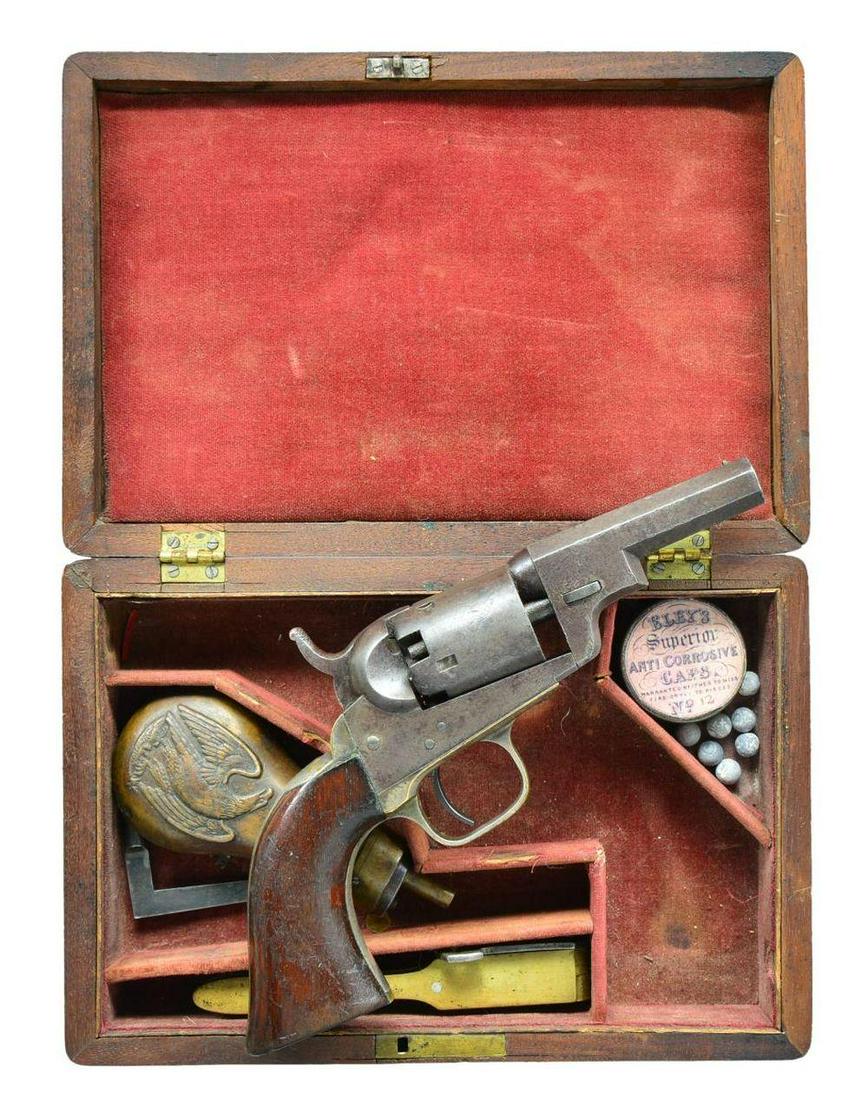 CASED COLT 1849 "WELLS FARGO" POCKET MODEL: REVOLVER. Cal. 31. S# 164125. Bbl. 3” octagon w/ New York address & bead sight. Known to collectors as the “Wells Fargo”, this desirable variation is made without the loading lever. 