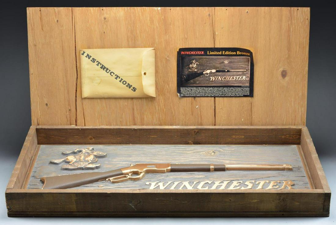 WINCHESTER 1866 CARBINE LIMITED EDITION BRONZE: PLAQUE. Designed & executed by Paul W. McCobb of Marblehead, MASS. This limited edition of 260 sculptures captures the spirit of the legendary Winchester rifle. Set against a barnwood background, it d