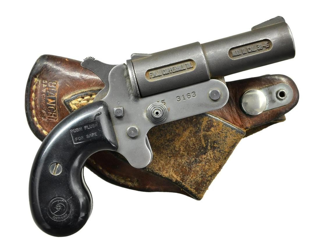 COBRAY MODEL D SINGLE SHOT DERRINGER BY FMJ.: Cal. 45 (45 LC & 410, 2 1/2"). S# 45 3163 . Bbl. 3 1/2". Open sights. Black finish. 2 Piece black plastic grips. UNATTACHED ACCESSORIES: Bianchi brown leather holster (meant for S&W Chief's Special re