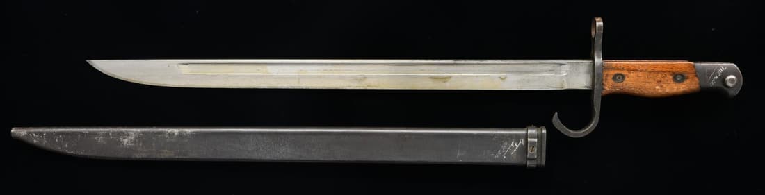 WWII JAPANESE TYPE 30 BAYONET WITH INSCRIPTIONS: FROM EUGENE SAMUEL MCGILL. According to the markings inscribed of the scabbard & written on a hang tag Eugene McGill served on a battleship USS Iowa. The Japanese bayonet scabbard is inscribed w/ a nu
