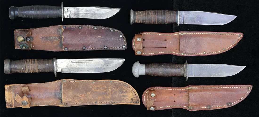 LOT OF 4 US WWII ERA FIGHTING KNIVES.: 1. Camillus Navy Mark 1 w/ leather scabbard. 5" blade. Blade marked "CAMILLUS/NY" on one side & "USN" on the other side. Blade shows scattered oxidation & some pitting. Fiberglass handles show scatter