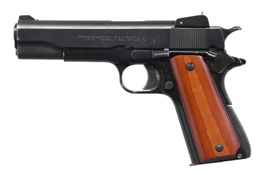 COLT 1911 SEMI A UTO PISTOL W/ CONVERSION UNIT.: Cal. 22 LR. S# 40694. Bbl. 4 3/4". WW1 1911 frame w/ right side "eagle/S8" inspection stamp. Later Colt 22 LR conversion kit slide w/ adj. aperture rear sight & blade front sight. Smooth wood grips. M