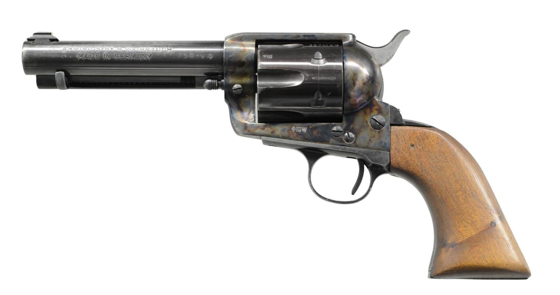 WEIHRAUCH ARMINIUS SAA REVOLVER.: Cal. 357 mag. S# P5915. Bbl. 5" with a dove-tailed replacement Lyman white bead front sight. Mfg. in Germany & imported by FIE. Blued barrel, cylinder & straps. Case-colored frame. Smooth 1-piece waln