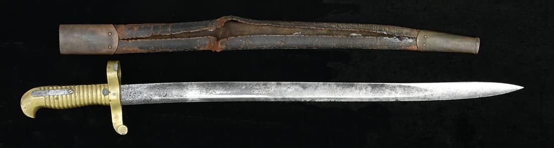 US M1862 REMINGTON ZOUAVE BAYONET.: This bayonet has an overall length of 24 7/8" with a blade length of 20 1/8". The blade has no visible markings. The hilt is solid brass and stamped "293" on the flat. Brass mounted leather scabbard. 