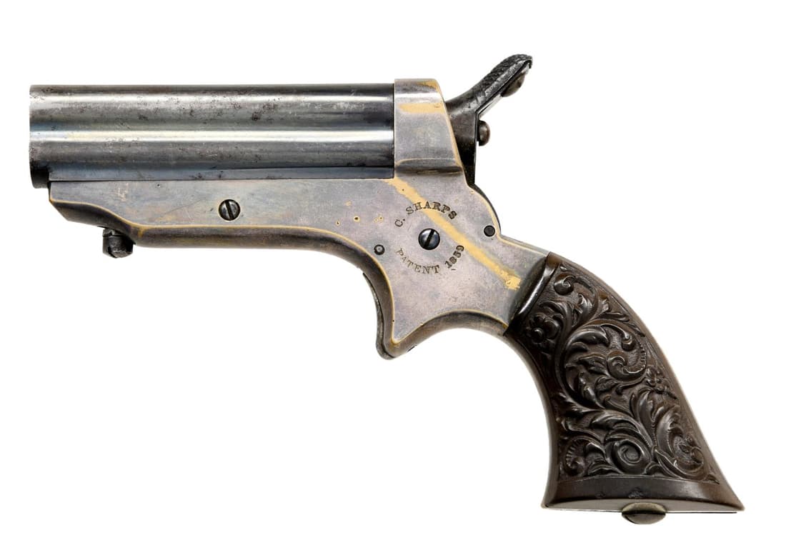 SHARPS MODEL 1 PEPPERBOX DERRINGER.: Cal. 22 RF. S# 24399. Bbl. 2 1/2" 4 Bbl. cluster. "C SHARPS PATENT 1859" left side frame & "C SHARPS & CO PHILADA PA" right side frame. Blued Bbls., brass frame & Gutta Percha grips. Bbl. release is b