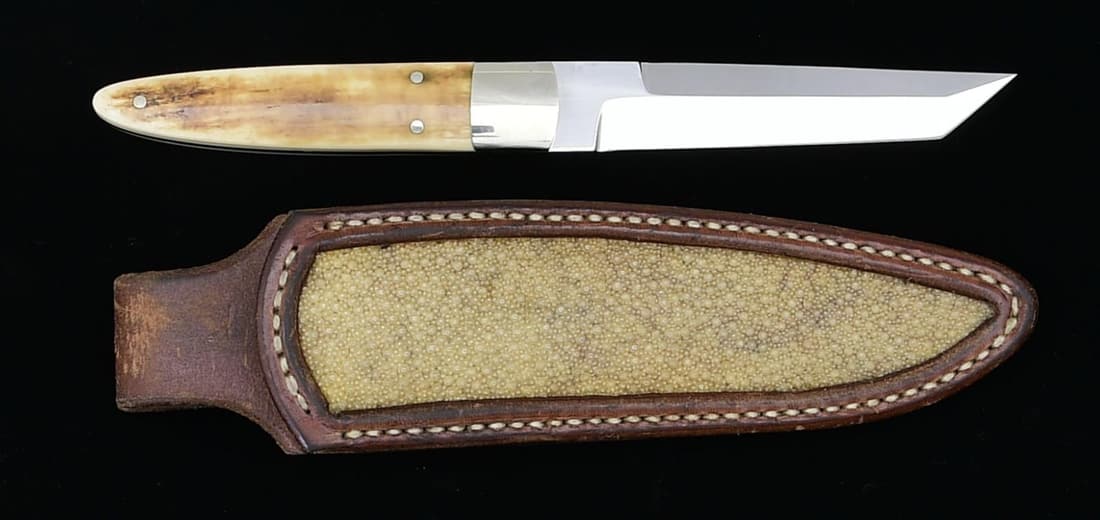 RODNEY ROGERS CUSTOM TANTO POINT PERSONAL STYLE: KNIFE. Overall: 9". Tanto point 4" blade w/ full tang. Nicle silver bolster. Stag panels. Brown leather sheath w/ exotic hide inlay. CONDITION: near excellent knife. Very good sheath w/ light wear. PR