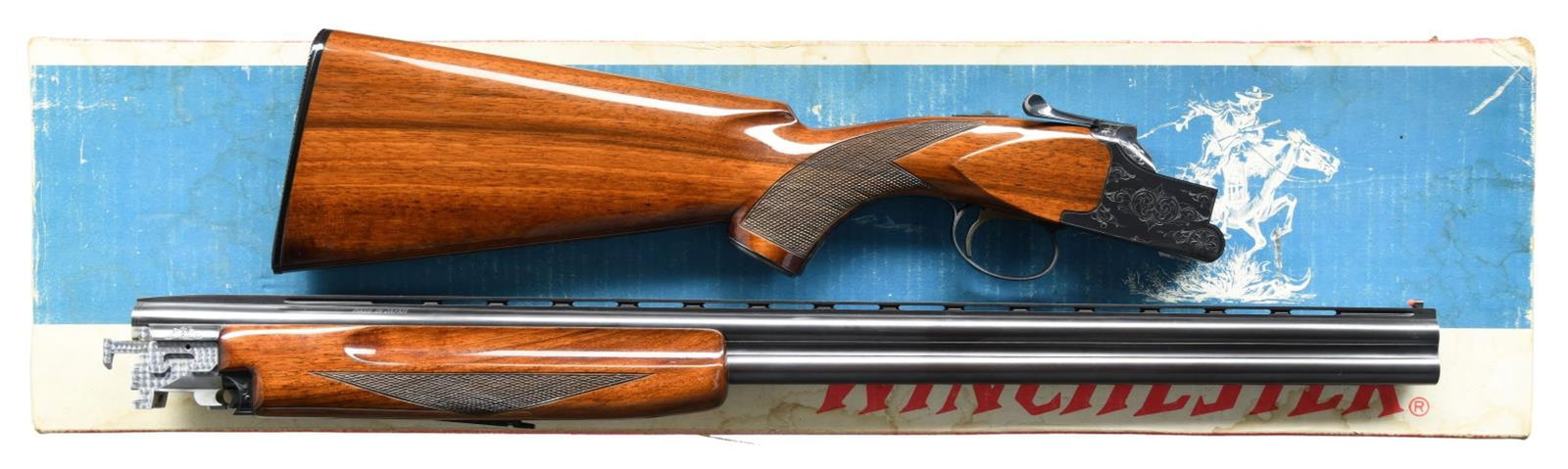 WINCHESTER MODEL 101 O/U SHOTGUN.: Cal. 20 ga. 2 3/4" & 3". S#. K244308. BBLS: 26 1/2" with vent rib. Red target front sight. Fixed Imp Cyl & Mod chokes. Blue finished action has scroll ornamentation. Selective ejectors & SST. Forend &