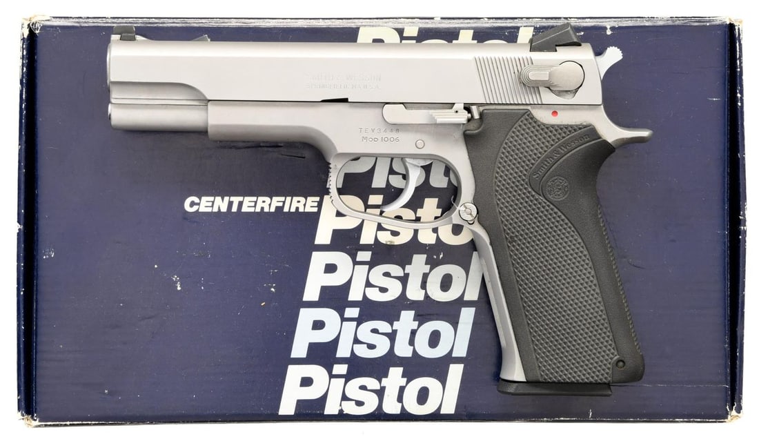 SMITH & WESSON MODEL 1006 SEMI AUTO PISTOL.: Cal. 10mm Auto. S# TEV3448. Bbl. 5". White dot sights. Ambidextrous serrated safety/decocker. Stainless finish. S&W checkered rubber grips. MAGS: 5-10 rd. factory stainless. UNATTACHED ACCESSORIES: fa