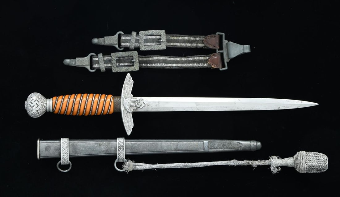 WWII GERMAN LUFTWAFFE DAGGER.: Overall length: 16 3/4". Plain blade marked near the hilt "(king) SMF SOLINGEN". Aluminum eagle crossguard & pommel. Iron oak leaf decorated ferrule. Aluminum wire-wrapped, orange composite grip. Plat