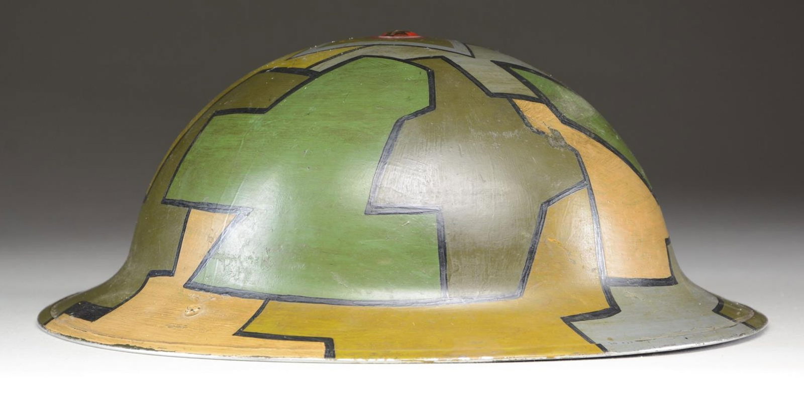 CANADIAN CORPS OF SIGNALS WWI HELMET.: This helmet is of classic WWI "doughboy" style with a camouflage painted finish in green, brown, tan, mustard, & gray. There is a screw attachment at the crown of the helmet. The interior right side i