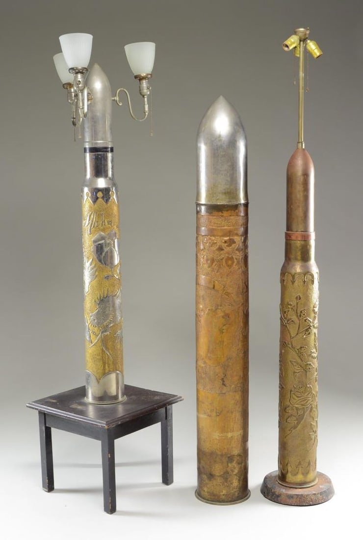 3 EXCEPTIONALLY LARGE PIECES OF TRENCH ART.: This group of trench art includes a large German battleship shell measuring 57 1/2" by approx. 7" across. The projectile is chrome plated and the entire brass shell is heavily embellished with repouss