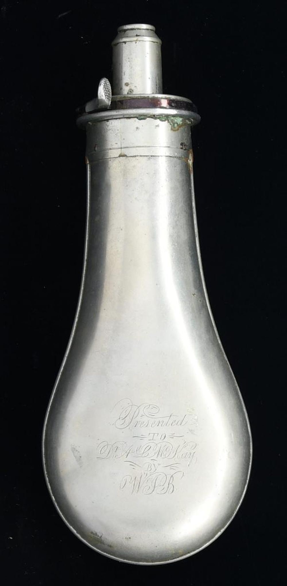 SILVERED PRESENTATION POWDER FLASK WITH: CONFEDERATE ASSOCIATION. This powder flask measures 8" in height and has a silver-plated body & charger. The body is engraved "Presented TO Dr. A. L. McKay BY W.I.B". The charger is marked "G & J.W HA