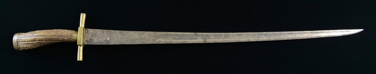 EUROPEAN HUNTING SWORD.: Overall length: 23 1/2". Blade length: 18 1/2". A good example of a 19th century European hunting sword, likely of French origin. The slightly curved blade has a single medium sized fuller and is etch