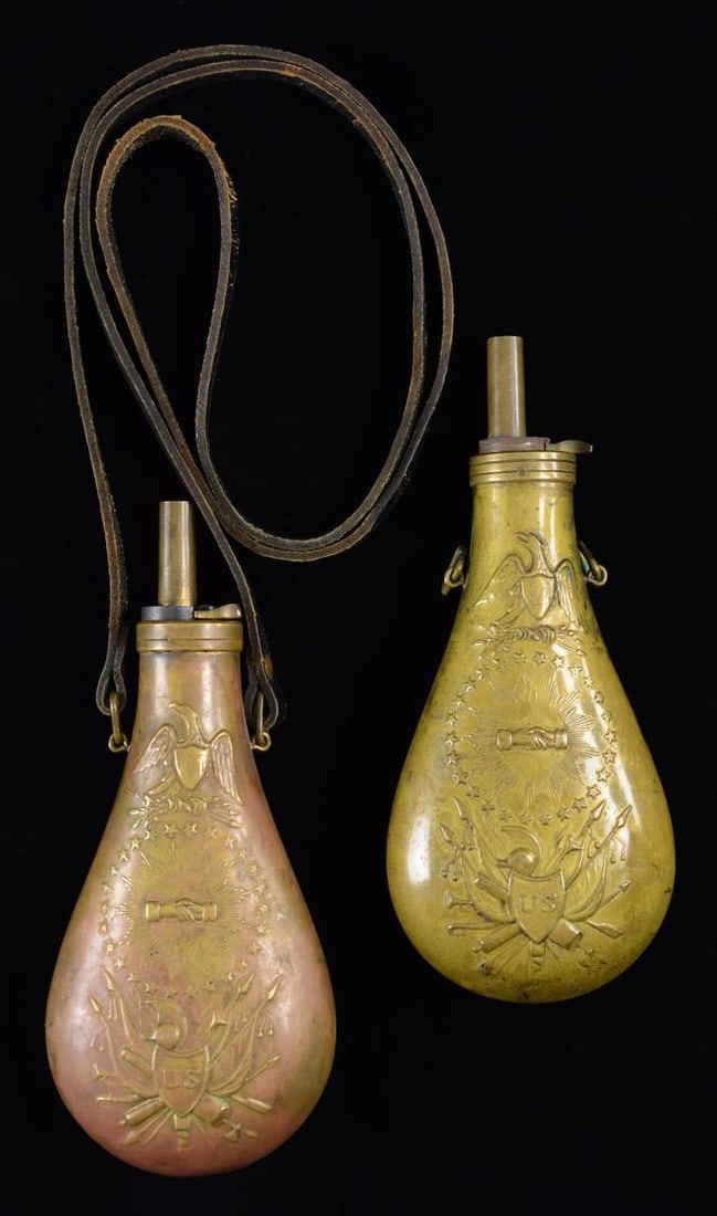 2 REPRODUCTION POWDER FLASKS.: Both of these flasks measure approx. 9" in height and about 4" in width. They have the classic peace design with an eagle over a ring of stars surrounding clasped hands with a spray of arms beneath. T