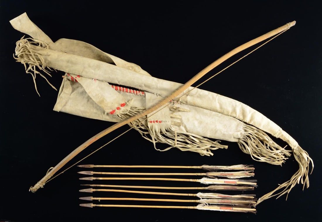 AMERICAN INDIAN BOW, ARROWS, QUIVER / BOW POUCH.: 43.5" Bow w/ twisted sinew string is held by rawhide bow bag attached to rawhide quiver. Both quiver & bow bag have red trade cloth decoration. Quiver holds six 25" arrows that appear to all be made b