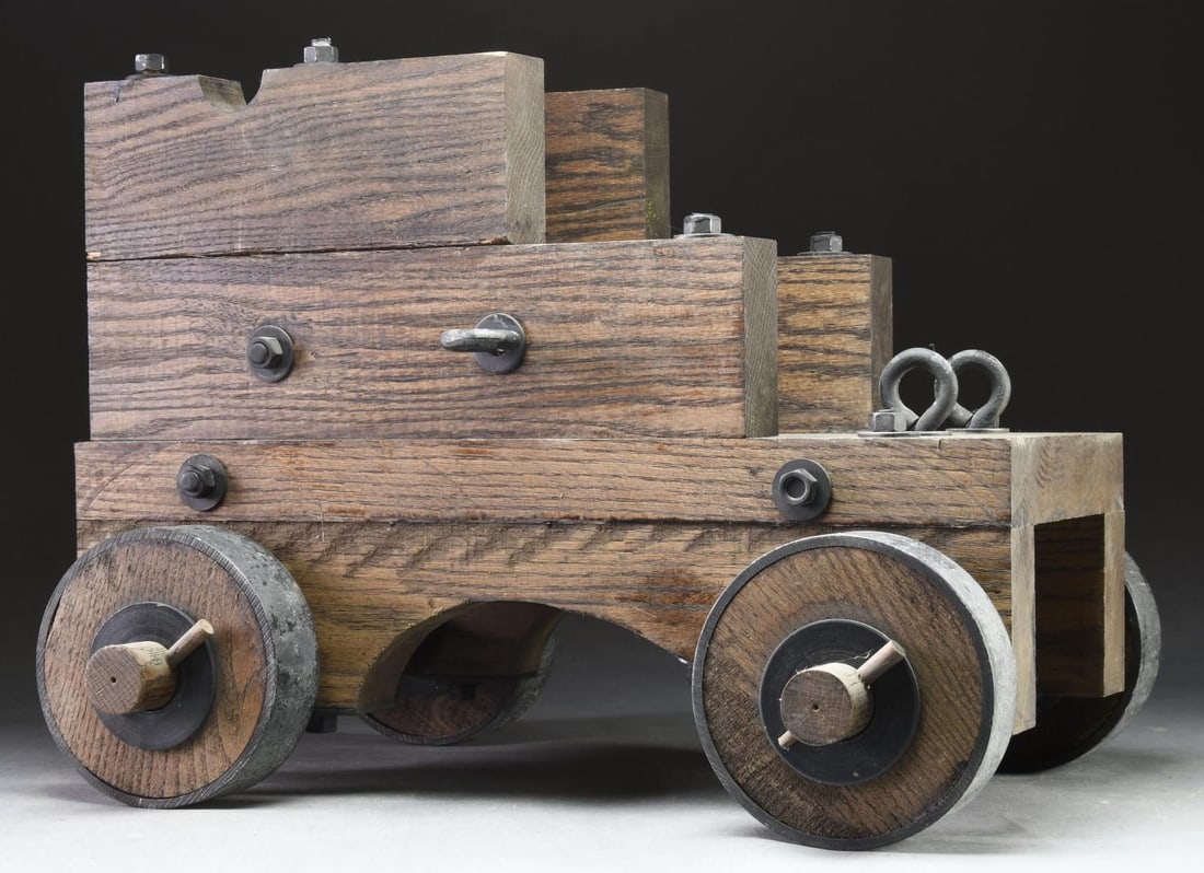 CONTEMPORARY CANNON CARRIAGE.: Contemporary cannon carriage that measures 24" in length & 10 1/2" in width. Wooden body & wheels w/ metal tires & mountings. CONDITION: wood shows scattered scratches & dings. Metal parts show scatte