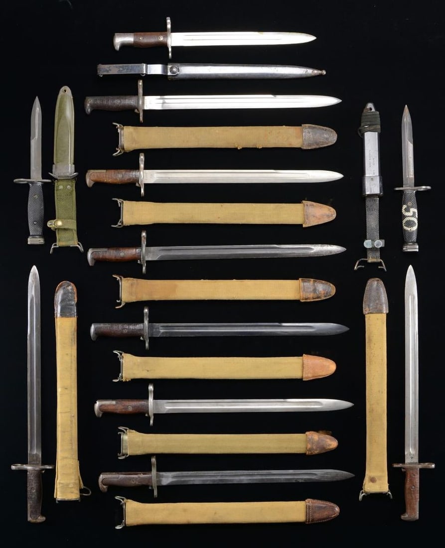 11 US BAYONETS.: This lot includes 7 US M1905 bayonets with wood grips & canvas-colored scabbards. / 1 US M1942 bayonet with a composite grip & canvas-colored scabbard. / 1 US M1892 Krag Jorgensen bayonet & scabbard w